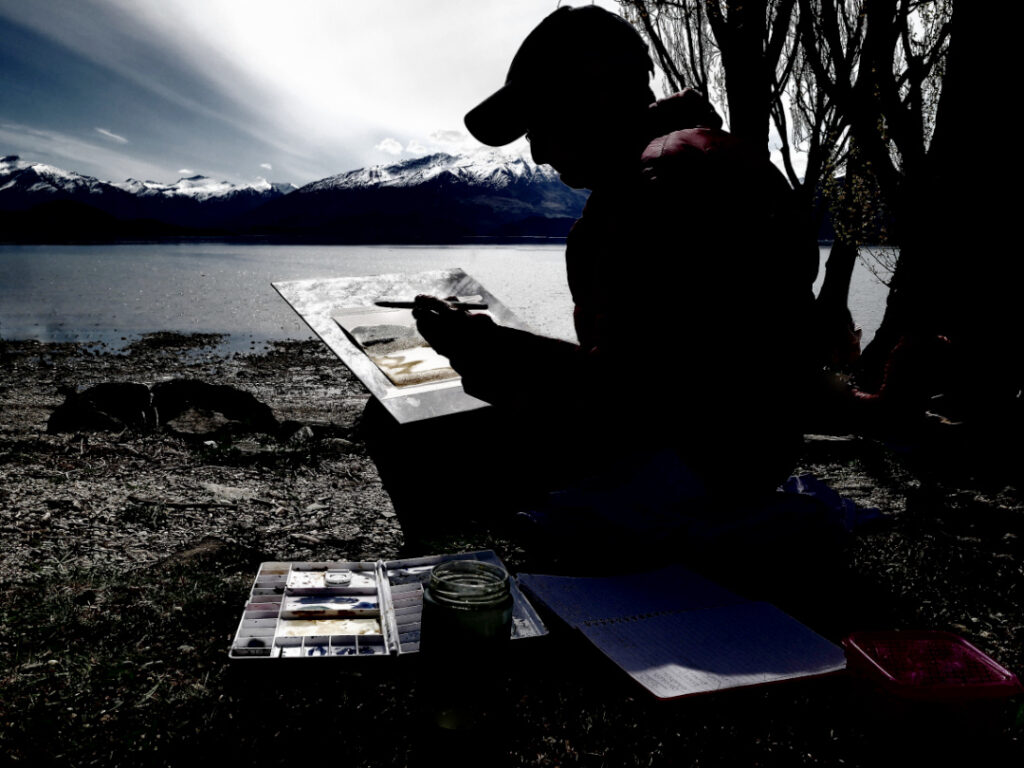 Water colour artist working on the shore of Lake Wanaka, New Zealand