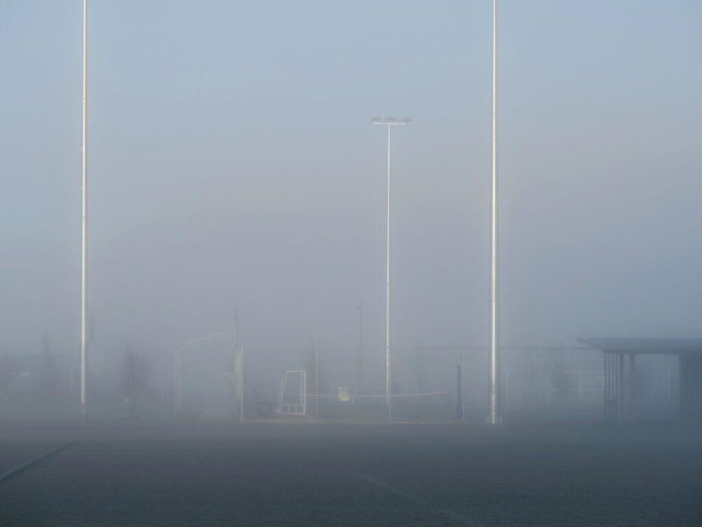 Hoar frost and tall night sport lights at sports fields Wanaka